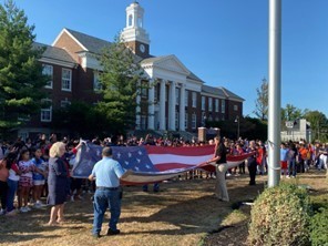 Staff Folding the Flag